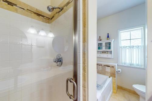 a bathroom with a shower and a toilet at WindRose in Lincoln City