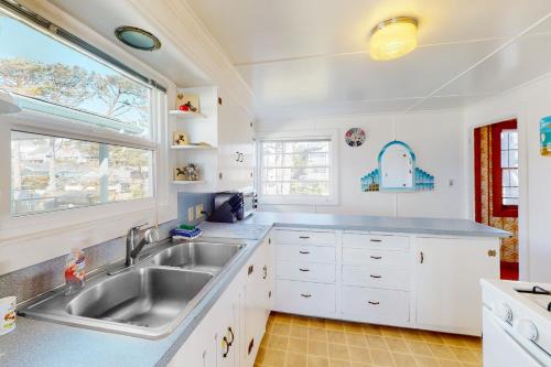 a kitchen with a sink and a window at Coastal Serenity in Lincoln City