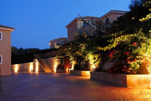 a cobblestone street with some buildings and lights at Hotel St John Villas in Tsilivi