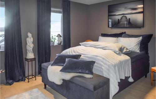 Un dormitorio con una cama y una silla con almohadas. en Nice Home In Halden With Kitchen en Halden
