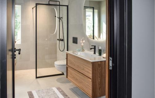 a bathroom with a shower and a sink and a toilet at Nice Home In Halden With Kitchen in Halden