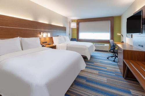 a hotel room with two beds and a flat screen tv at Holiday Inn Express & Suites Brunswick-Harpers Ferry Area by IHG in Brunswick