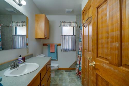 a bathroom with a sink and a toilet and a mirror at Cozy Las Cruces Home - 2 Mi to New Mexico State! in Las Cruces