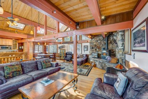 a living room with couches and a stone wall at Peaceful Forest Retreat in Carnelian Bay