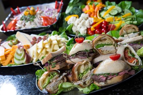 a plate of food with sandwiches and a salad at Holiday Inn Montreal Longueuil by IHG in Longueuil