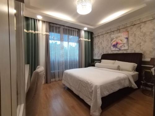 a bedroom with a bed and a large window at Grand Illusyin in Shah Alam