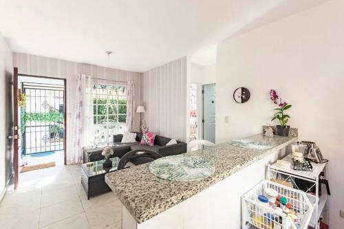 a kitchen and living room with a counter top at Cozzy Flamingo Renta Vacacional in Concepción de La Vega