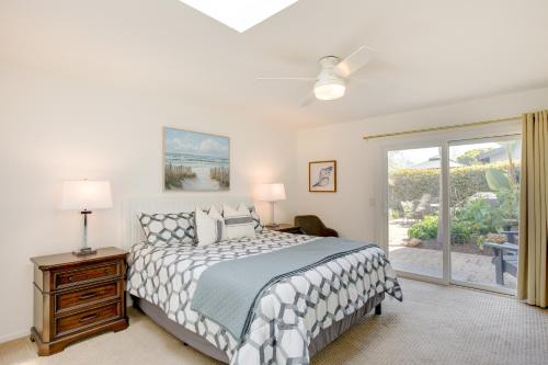 a bedroom with a bed and a sliding glass door at Lakefront Grover Beach Home about Walk to Ocean! in Grover Beach