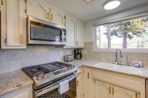 a kitchen with a stove and a sink and a window at Lakefront Grover Beach Home about Walk to Ocean! in Grover Beach