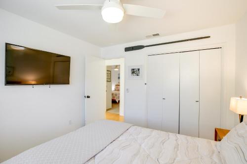 a white bedroom with a bed and a tv at Lakefront Grover Beach Home about Walk to Ocean! in Grover Beach
