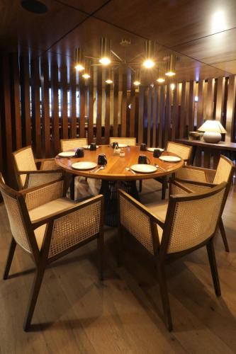 a dining room with a wooden table and chairs at Culiacan Marriott Hotel in Culiacán
