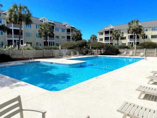 a large swimming pool in front of a building at Port O' Call G304 - Modern Oceanview! Atlantic Escape! in Isle of Palms