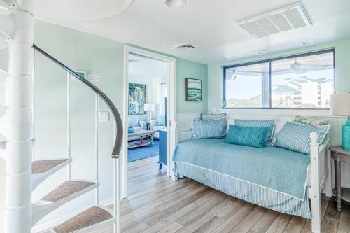 a bedroom with a bed with blue pillows at Port O' Call G304 - Modern Oceanview! Atlantic Escape! in Isle of Palms