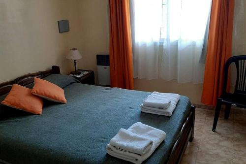 a bedroom with a bed with towels on it at Departamento muy amplio y cómodo. Impecable! PB in San Rafael