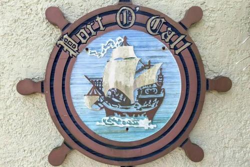a wooden plate with a pirate ship on a wall at Port O' Call C302 - IOP Island Retreat! Treetop Oceanview! in Isle of Palms