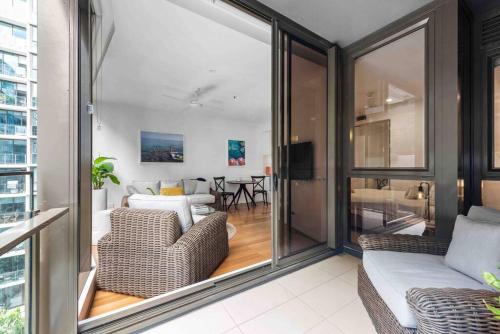 a living room with a couch and a table at Newstead Ideally Located 2bed 2Bath Free Parking in Heart of Everything in Brisbane