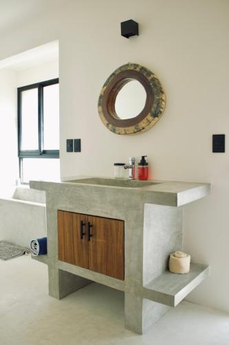 a bathroom with a sink and a mirror on the wall at Casa Luni in Puerto Escondido