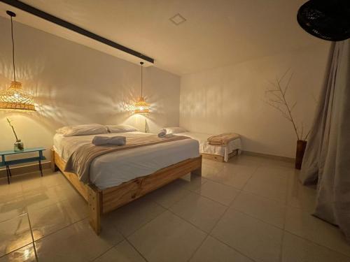 Postel nebo postele na pokoji v ubytování Hotel Neblina Calima
