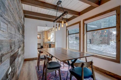 a dining room with a wooden table and chairs at Extra Spacious 2BR Cabin w Office and Outdoor Deck in Incline Village