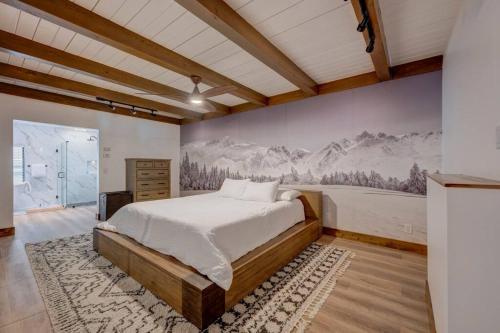 a bedroom with a bed and a painting on the wall at Extra Spacious 2BR Cabin w Office and Outdoor Deck in Incline Village