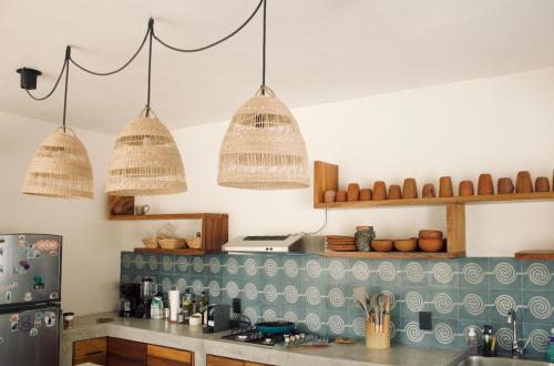 a kitchen with two baskets hanging from the ceiling at Casa Luni in Puerto Escondido