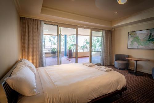 a hotel room with a bed and a large window at Apartment 2, 9 River Lane Mannum in Mannum