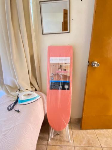 a room with a red board next to a bed at Casa ALOA Ixtapa in Ixtapa