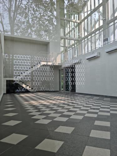 an empty room with a checkered floor and windows at Una Residence by Maya in Kuala Lumpur