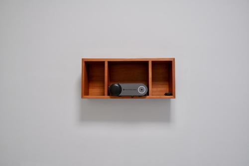a speaker in a wooden cabinet on a wall at Boy apartment -Adult only in Hualien City