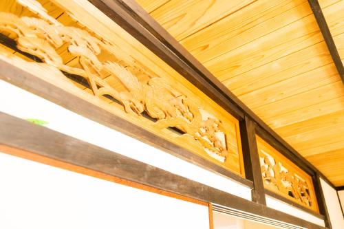 a wooden ceiling with a carving on it at ikkyu rental vacation house in Kobune