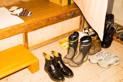 a group of shoes are lined up next to a counter at ikkyu rental vacation house in Kobune