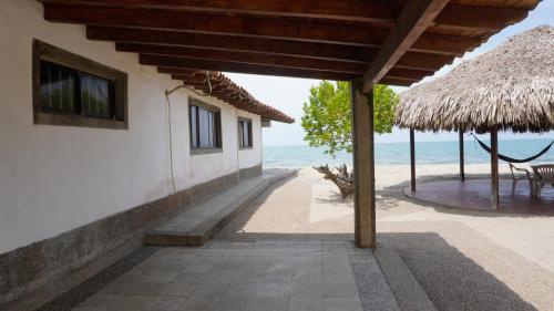 a building on the beach with a view of the ocean at Cabaña Aire Viento Sol in Puerto Viejo