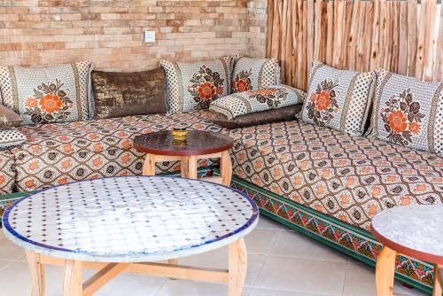 a living room with a couch and a table at Riad Les Nuits De Fès in Fès