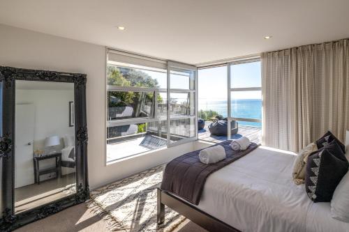 a bedroom with a bed and a view of the ocean at Bellevue in Onetangi