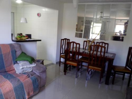 a living room with a couch and a table and chairs at Quartos Prox Engenhão e Norte Shopping in Rio de Janeiro