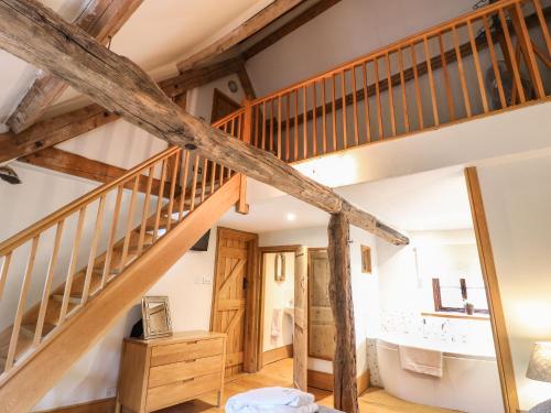 an attic bathroom with a staircase and a sink at Castle Combe Cottage in Castle Combe