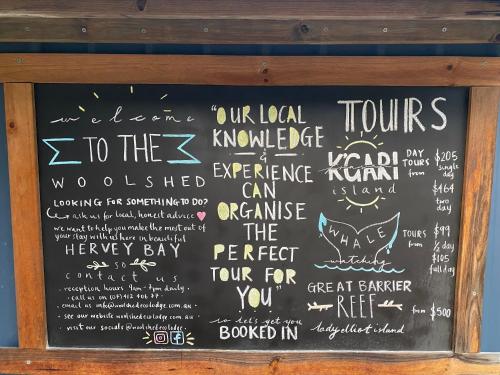 a chalkboard with some writing on it at Woolshed Eco Lodge in Hervey Bay