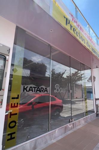 a reflection of a car in the windows of a car dealership at Katara Boutique Hotel in Mariquita