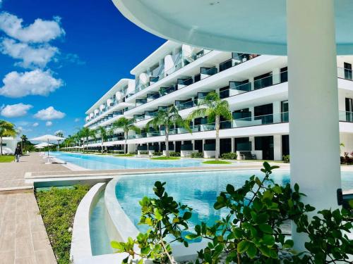 a large apartment building with a swimming pool at Cana Rock Star luxury condo, Casino, golf, beach in Hard Rock área in Punta Cana