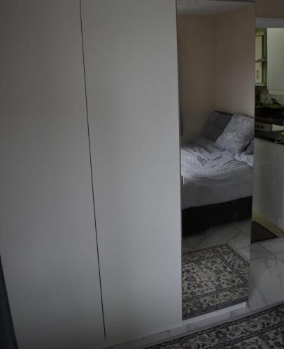 a bedroom with a mirror and a bed at Shaz,s House in Cowley