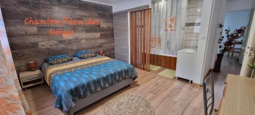 1 dormitorio con 1 cama y una pared con un cartel en Chambre d'hôte Les Amoureux du Cirque en Cilaos