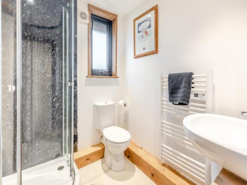 a bathroom with a shower and a toilet and a sink at Piglets House - Uk43488 in Aldington