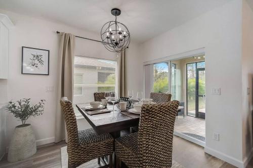 a dining room with a table with chairs and a chandelier at Family Villa King Bed, 3 bedrooms 2baths, 7 guests, Close to Beaches, Golfing, Fishing in Rotunda-West