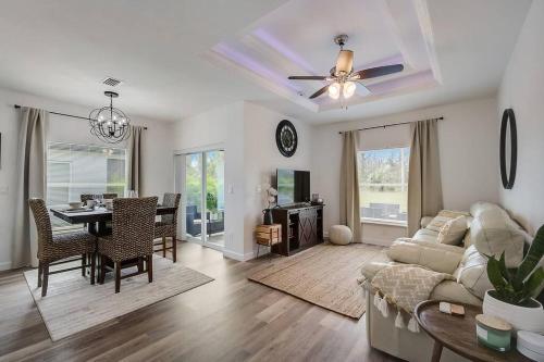 a living room with a couch and a table at Family Villa King Bed, 3 bedrooms 2baths, 7 guests, Close to Beaches, Golfing, Fishing in Rotunda-West