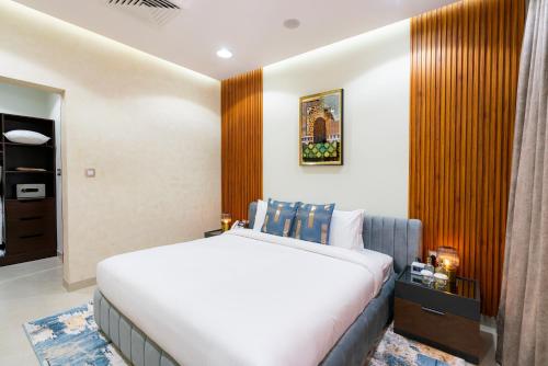 a bedroom with a large bed and a wooden wall at Damask Resort in Jabal Al Akhdar
