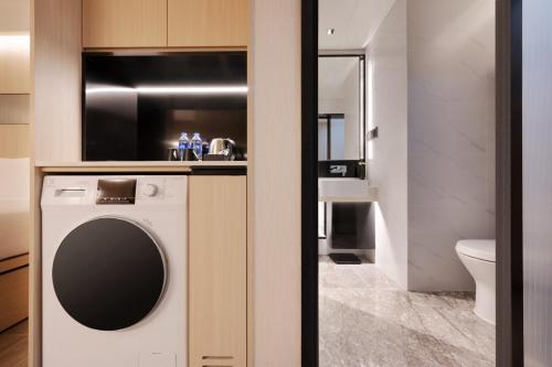 a bathroom with a washing machine and a sink at Metropolitan Residence in Shanghai