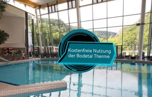 ein Pool mit einem Schild, das neurowissenschaftliche Pflege für Flaschentherapie liest in der Unterkunft Hotelpark Bodetal mit Ferienwohnungen in Thale