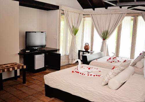 Postel nebo postele na pokoji v ubytování Hotel Henry Morgan All Inclusive