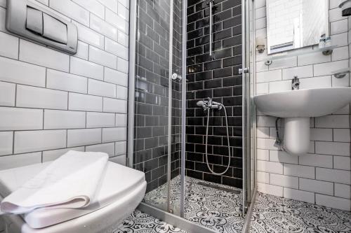a bathroom with a toilet and a sink at Hotel Centro Bodrum in Bodrum City