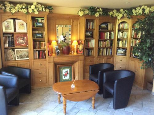 a room with chairs and a table and a fireplace at Residence Hotel Les Ducs De Chevreuse avec Hébergement, Repas & PDJ, Séminaire, Bureau & Parking in Chevreuse
